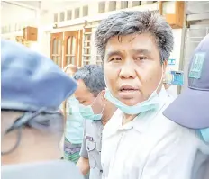  ?? photo — AFP ?? Nay Myo Lin is escorted from his home by police to court in Mandalay.