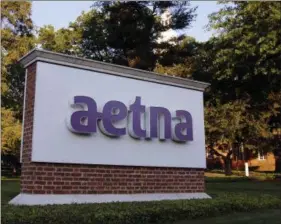  ?? BILL SIKES — THE ASSOCIATED PRESS FILE ?? In this file photo, a sign stands on the campus of the Aetna headquarte­rs, in Hartford, Conn. CVS will buy insurance giant Aetna in a roughly $69 billion deal that will help the drugstore chain provide more health care and keep a key client, according...