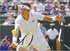  ?? Associated Press photo ?? Canada's Milos Raonic returns to Spain's Albert Ramos-Vinolas during their Men's Singles Match on day six at the Wimbledon Tennis Championsh­ips in London Saturday.