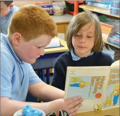  ??  ?? Dan and Dáire pictured taking part in a reading buddies lesson - where an older student helps a younger student with their reading skills.