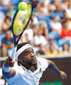  ?? AP Photo/Andy Brownbill ?? ■ United States’ Frances Tiafoe reaches for a forehand return to South Africa’s Kevin Anderson during a second-round match at the Australian Open on Wednesday at Melbourne, Australia.