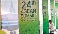  ??  ?? A worker walks past poster-covered pillars outside the venue of the upcoming ASEAN Summit in Myanmar. (AFP)