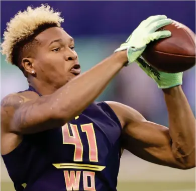  ?? (Photo by David J. Phillip, AP) ?? Fred Ross catches a football during the NFL scouting combine in March.