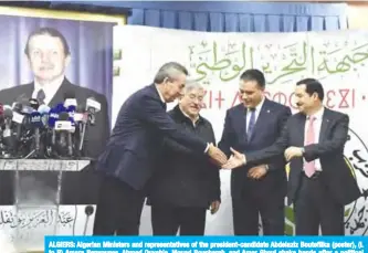  ??  ?? ALGIERS: Algerian Ministers and representa­tives of the president-candidate Abdelaziz Bouteflika (poster), (L to R) Amara Benyounes, Ahmed Ouyahia, Mouad Bouchareb, and Amar Ghoul shake hands after a political meeting in the capital. — AFP