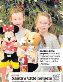  ??  ?? Santa’s little helpers Emma and Emily McHugh made sure kids in hospital didn’t miss out this Christmas