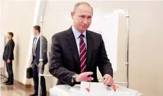  ??  ?? Putin casts his ballot at a polling station during the municipal elections in Moscow. — Reuters photo