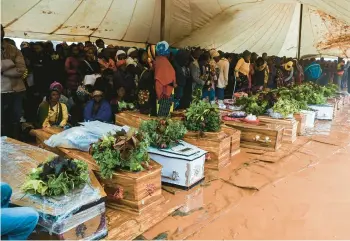  ?? THOKO CHIKONDI/AP ?? Mourners attend a burial ceremony Wednesday in Blantyre, southern Malawi, for some of those who were killed due to heavy rains caused by Cyclone Freddy. After barreling through Mozambique and Malawi since late last week, killing more than 250 people and displacing tens of thousands in the two countries, the cyclone is set to move away from land.