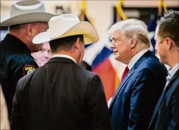  ?? Brandon Bell / Associated Press ?? Former President Donald Trump greets law enforcemen­t while arriving Wednesday at a border security briefing in Weslaco, Texas.
