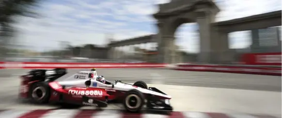  ?? RICHARD LAUTENS/TORONTO STAR ?? Graham Rahal speeds past the Princes’ Gate at Exhibition Place during a qualifying run Saturday. Rahal had the second fastest qualifying time and starts near the front for the big race today.