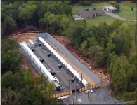  ?? ?? An aerial view on Oct. 4 shows a bitcoin mine that was built next to Gladys Anderson’s property (right) in Greenbrier.
(The New York Times/Rory Doyle)