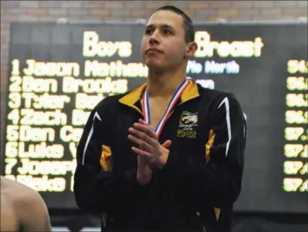  ?? JON BEHM — THE MORNING JOURNAL ?? Avon senior Ben Brooks looks to the Avon cheering section as he stands on the podium following his second-place finish in the 100 breaststro­ke at the D-I State swim meet at C.T. Branin Natatorium in Canton on Feb. 25. Brooks posted a time of 56.28.