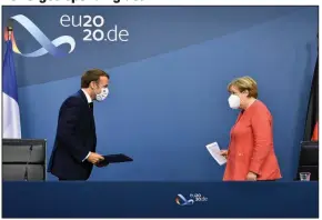  ?? (AP/John Thys) ?? French President Emmanuel Macron and German Chancellor Angela Merkel prepare to announce an $857 billion European Union stimulus agreement Tuesday in Brussels. European Union leaders finally clinched an unpreceden­ted budget and coronaviru­s recovery fund after four days of negotiatio­ns. More photos at arkansason­line.com/722summit/.