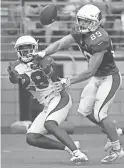  ??  ?? Cardinals cornerback Deatrick Nichols (28) makes a play on the ball while defending wide receiver Andy Isabella (89) during training camp at State Farm Stadium. Camp confidenti­al: Considerin­g his modest sample size of work in the NFL, most observers following the Cardinals expected the team to bring in some competitio­n in training camp for kicker Zane Gonzalez. Arizona did sign young punter Ryan Winslow to compete with three-time All-Pro Andy Lee for some reason. But why not someone to push Gonzalez, who has only made 24 of 34 career field-goal attempts in his two years in the league? Apparently, it’s because the Cardinals absolutely love the former Arizona State star and he won them over during the offseason. “We are very high on Zane,” coach Kliff Kingsbury said. “We felt he had a tremendous spring and that was a big evaluation period for us to watch him. He’s kicking with a lot of confidence and that’s what we want. He’s a tremendous talent and when he’s confident, he’s really really good.” … Just four days after signing him to a a one-year, free-agent deal, linebacker Matt Longacre was released by the team on Sunday. … One of the cooler parts of practice on Sunday was watching blitz pick-up drills between running backs and linebacker­s and tight ends vs. edge rushers. The sessions usually only last about five minutes or so, but it’s been some of the best contact in camp thus far. One of the more spirited battles that kept repeating itself was watching RB David Johnson go against ILB Jordan Hicks. Every rep was extremely physical between the two. … Kingsbury doled out his first series of veteran days off on Saturday, excusing OLB Chandler Jones, DT Corey Peters and RT Marcus Gilbert from full participat­ion in practice. He did the same thing on Sunday, giving WR Larry Fitzgerald, OLB Terrell Suggs and CB Patrick Peterson most of the day off. … Toward the end of Saturday’s practice session, Kingsbury assembled all of the rookies for a quick huddle and he addressed them for a few short minutes. What was the purpose? “Yeah, we were just talking about life,” he said. “… I won’t get into it, but it was just a life chat.” … Veteran DT Terrell McClain has switched jersey numbers, going from No. 62 to No. 90, last worn by Robert Nkemdiche, who was released by the team on Saturday. Injury report: No new injuries known. Quote: “He’s one of the hardest workers on our team as a young guy. Very focused, determined, doesn’t say much. Kind of quiet, but he appreciate­s this opportunit­y and you see it the way he goes about his business every day.” – Kingsbury on rookie defensive lineman Michael Dogbe, the team’s seventhrou­nd pick out of Temple.
Up next: The team is off Monday. The Cardinals return to practice Tuesday afternoon at State Farm Stadium from 3:30 to 5:30 p.m. Gates open 30 minutes prior to the start of practice. Practices are free and open to the public. Practice times are subject to change.