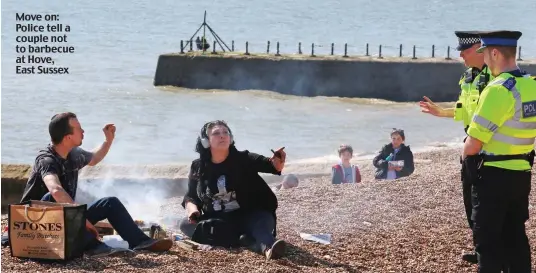  ??  ?? Move on: Police tell a couple not to barbecue at Hove, East Sussex