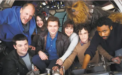  ?? Jonathan Olley / Lucasfilm ?? Cast members and ex-co-directors of the Han Solo spin-off: Christophe­r Miller (bottom left), Woody Harrelson, Phoebe Waller-Bridge, Alden Ehrenreich, Emilia Clarke, Joonas Suotamo as Chewbacca, Phil Lord and Donald Glover.