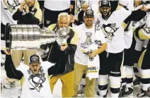  ?? JOSIE LEPE/STAFF ?? Sidney Crosby carries the Stanley Cup after the Penguins won the series over the Sharks last June. The two teams meet again Thursday.