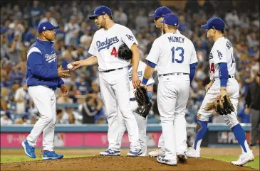  ?? GETTY IMAGES ?? Dodgers manager Dave Roberts pulled starter Rich Hill in Game 4 of the World Series after he gave up one hit through 6⅓ innings and was ahead 4-0. The Dodgers ended up using six relievers and lost 9-6.