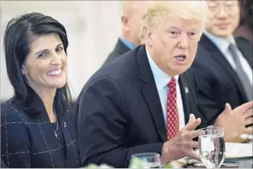  ?? Brendan Smialowski AFP/Getty Images ?? AT A WHITE HOUSE meeting last week with Ambassador Nikki Haley and members of the U.N. Security Council, President Trump joked: “Does everybody like Nikki? Otherwise, she can easily be replaced.”