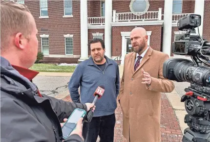  ?? PROVIDED BY THE FIRST LIBERTY INSTITUTE ?? Chris Avell, middle, with his lawyer, Jeremy Dys, is suing the city of Bryan, Ohio, after his church, which also operates as a warming center for the needy, was cited with criminal zoning infraction­s.