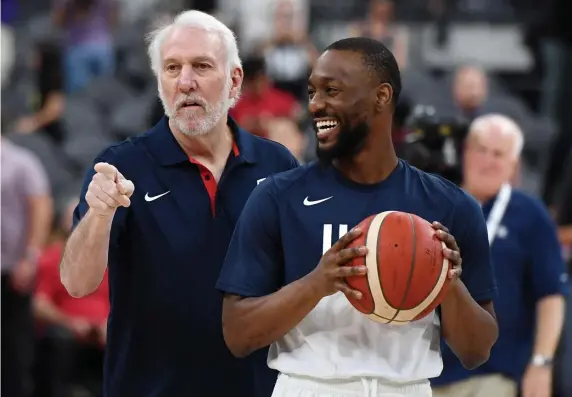  ??  ?? TALKING SHOP: Celtic Kemba Walker gets a laugh as he talks with U.S. National team coach Gregg Popovich before their Blue-White exhibition game Friday night in Las Vegas.