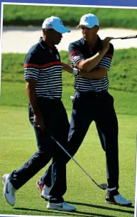  ??  ?? FRUSTRATIO­N: Tiger Woods (left) speaks with Jordan Spieth during a Ryder Cup practice session