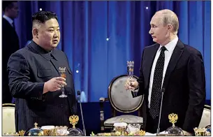  ?? AP/Sputnik/ALEXEI NIKOLSKY ?? North Korean leader Kim Jong Un and Russian President Vladimir Putin share a toast Thursday after their talks in Vladivosto­k, Russia. On sharing the substance of the talks with President Donald Trump, Putin said: “There are no secrets. Russia’s position always has been transparen­t. There are no plots of any kind.”