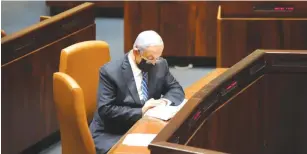  ?? ( Dani Shem Tov/ Knesset Spokespers­on) ?? PRIME MINISTER Benjamin Netanyahu reads during a Knesset vote yesterday on a bill that would prevent those under criminal indictment from serving as prime minister.