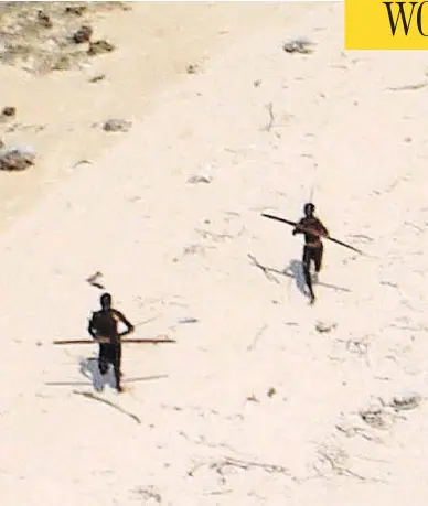  ?? INDIAN COAST GUARD ?? Tribesmen with bows are seen on India’s North Sentinel island, a remote area untouched by modern civilizati­on.