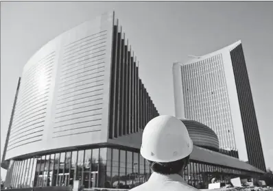  ?? WANG SHEN / XINHUA ?? A technician inspects the exteriors of the African Union Commission Conference Center, a project executed by the China State Constructi­on Engineerin­g Corp, in Addis Ababa, capital of Ethiopia.