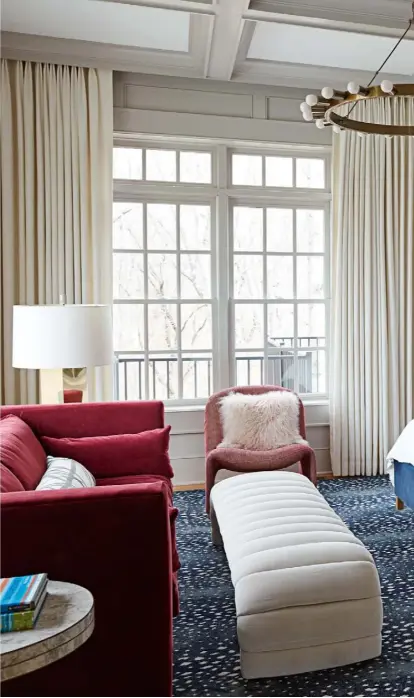  ??  ?? Main bedroom A spotted rug by Stark and a curvaceous velvet footstool from antiques dealer Stephanie Schofield add a sense of fun to this sophistica­ted room. The pendant light is by Clayton Gray Home and the side chair is the ‘Alky’, designed by Giancarlo Piretti in the 1970s for Artifort
See Stockists page for details