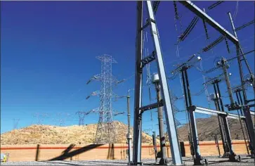  ?? Photograph­s by Gary Coronado Los Angeles Times ?? ELECTRIC TRANSMISSI­ON lines connect at a Southern California Edison substation in Palmdale. The lines are part of a key power corridor known as Path 26, which carries Pacific Gas & Electric wires as well.