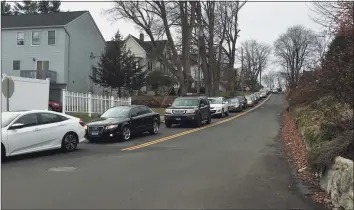  ?? Karen Tensa / Hearst Connecticu­t Media ?? Cars lined up Tuesday afternoon on Wilson Street in Danbury before the COVID-19 testing site at 118 Memorial Drive opened.