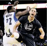  ?? Ezra Shaw / Getty Images ?? Stephen Curry reacts to winning a jump ball against Minnesota rookie Andrew Wiggins. Curry scored a game-high 25 points and had six assists as the Warriors got back to winning.