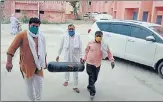  ?? SOURCED ?? Gaurav Tikait (in saffron kurta) and others bringing an oxygen cylinder at PHC in Sisauli town of Muzaffarna­gar.