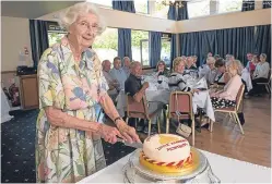  ?? Picture: Andy Thompson ?? Mrs Thomson cuts the cake at the class reunion.