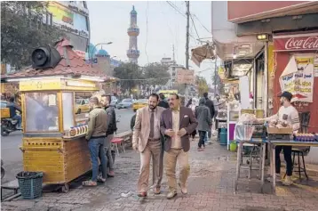  ??  ?? In Iraq’s capital city, many believe they enjoy a herd immunity from COVID-19, which has infected almost 100 million people and killed more than 2 million worldwide. Above, a busy street Jan. 17 in Baghdad.