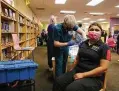  ?? Kin Man Hui / Staff photograph­er ?? Sandra Alvarez, right, a cafeteria assistant manager in Southside ISD, gets the Moderna vaccine at Pearce Elementary.