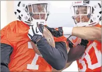  ?? [CHRIS LANDSBERGE­R/THE OKLAHOMAN] ?? Oklahoma State running backs LD Brown, left, and Chuba Hubbard go through drills on Monday during spring practice in Stillwater.