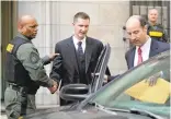  ?? PATRICK SEMANSKY/ASSOCIATED PRESS ?? Officer Edward Nero, center, leaves the courthouse on Monday after being acquitted of all charges.