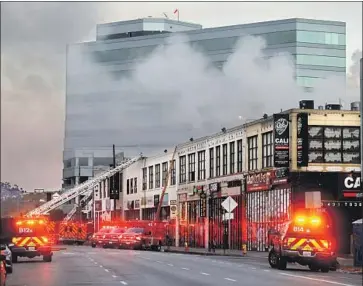  ?? Gary Coronado Los Angeles Times ?? CREWS battle a blaze that led to an explosion on Boyd Street in downtown L.A. in May. Charges against Steve Sungho Lee and others allege they illegally stored hazardous materials and endangered public health.