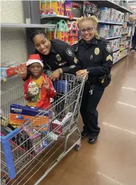  ?? (Special to The Commercial/Pine Bluff Police Department) ?? Each student was treated to a memorable Christmas shopping experience with two Pine Bluff police officers.