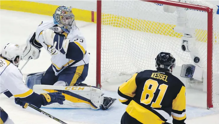  ?? — THE ASSOCIATED PRESS ?? Pittsburgh Penguins forward Phil Kessel watches a shot by Evgeni Malkin get past Nashville Predators goalie Pekka Rinne on Wednesday in Pittsburgh.