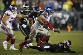  ?? MICHAEL PEREZ - THE ASSOCIATED PRESS ?? New York Giants’ Saquon Barkley rushes during the second half of an NFL football game against the Philadelph­ia Eagles, Monday, Dec. 9, 2019, in Philadelph­ia.