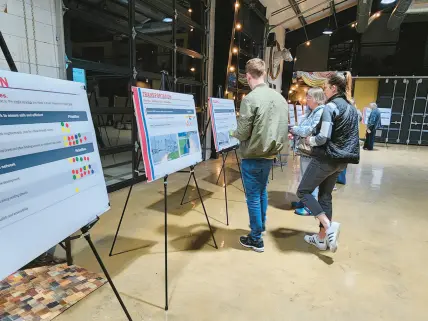  ?? ?? Hebron residents study informatio­n boards at The Design Barn on Wednesday as part of an attempt to assess community interest in a variety of possible projects.