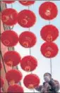  ??  ?? A man installs Chinese lanterns ahead of the Lunar New Year, in Beijing.
