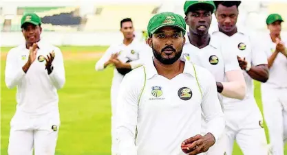  ?? LENNOX ALDRED ?? Man-of-the-Match Veerasammy Permaul is applauded off the field by his teammates after picking up eight wickets against the Jamaica Scorpions on day three of their West Indies Championsh­ip match at the Trelawny Multipurpo­se Stadium.
