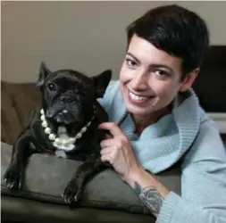  ?? KEN FAUGHT ?? Carli Stephens-Rothman with her dog, Fig, a seven-and-a-half-year-old French bulldog, complete with pearls. The circumstan­ces of pet ownership and parenthood aren’t the same but feelings that come with each can be, Stephens-Rothman writes.