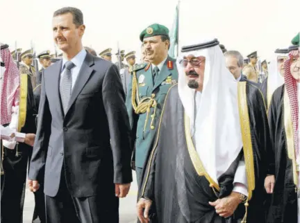  ??  ?? In this March 11, 2009 file photo, King Abdullah of Saudi Arabia (right) welcomes Syrian President Bashar Assad upon his arrival to attend the Arab Summit, in the Saudi capital Riyadh.