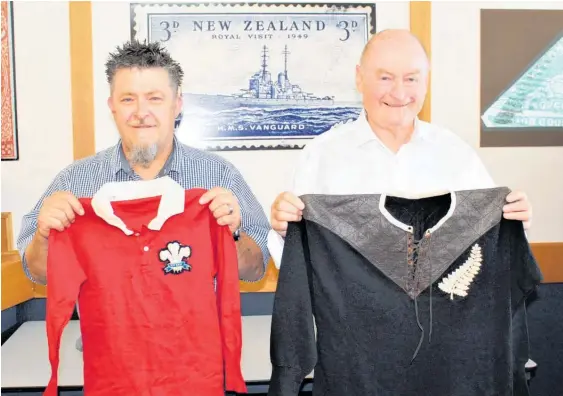  ?? ?? Mowbray Collectabl­es' Brendan Watson (left) and John Mowbray, with a Welsh and All Blacks jersey from 1905.