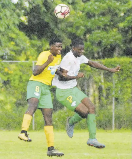  ?? (Photos: Paul Reid) ?? Petersfiel­d High’s Shewayne Barton (left) and Knockalva Technical’s Markel Walker battle for the ball in their ISSA/WATA Zone D first-round game played in Ramble, Hanover on Thursday. The game ended in a 1-1 draw.